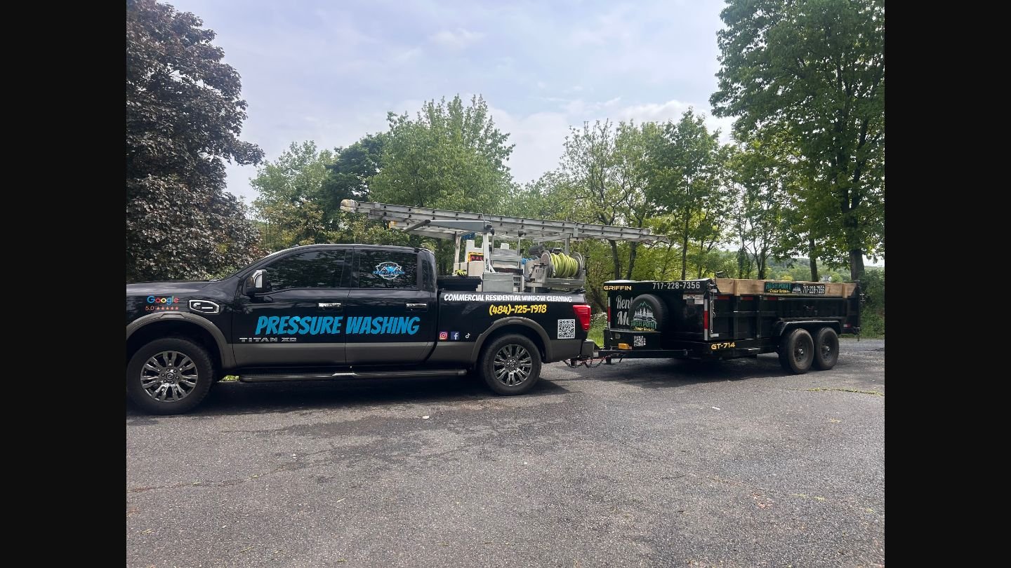 Professional pressure washing truck and trailer setup with commercial equipment